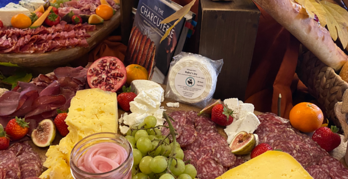 cheese, meats, fruit decoratively displayed.