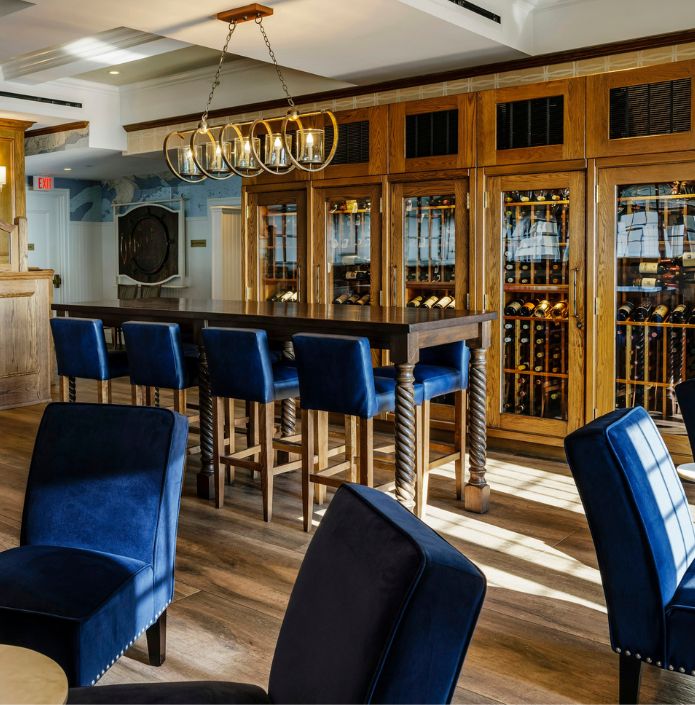 bar area with chairs and tables and wine cabinets