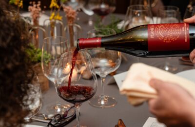 pouring glass of wine at dinner event